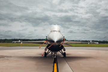 Modern jet fighter on the runway of airport parking