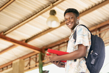young black man with a backpack and a red folder © Boijonell