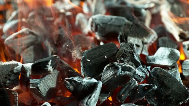 Super Slow Motion Shot of Glowing Charcoal Briquettes on Garden Grill. Filmed on High Speed Cinematic Camera at 1000 FPS.