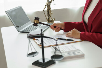 Attorney's office. Goddess of justice with scales and lawyer working on laptop Law, advice and...
