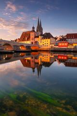 Regensburg, Germany. Cityscape image of Regensburg, Germany with Old Stone Bridge over Danube River and St. Peter Cathedral at autumn sunrise.