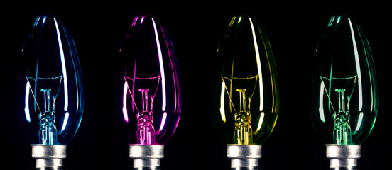 Light bulbs with multi-colored glass on a black background. Tungsten lamps in turquoise, purple,...