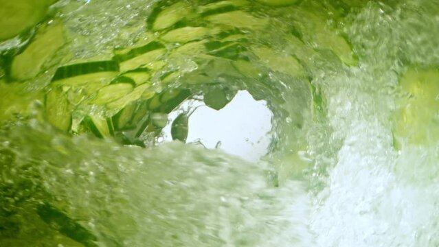 Super slow motion of water wave with sliced cucumber. Filmed on High Speed Cinematic Camera at 1000 FPS