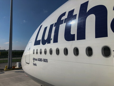 Lufthansa double decker Airbus A380 partial fuselage with windows and livery against blue sky taken at Munich Airport on 15 September 2023