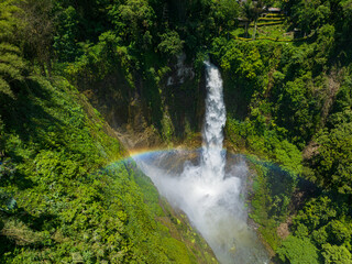 Naklejka na ściany i meble Aerial view of waterfalls wih rainbow. Beautiful splashing of of water from falls. Dongon Seven Falls in Lake Sebu. Mindanao, Philippines.
