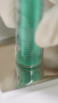 Vertical video. Close up of burning needles in a medical destructor burning used syringes. Flashes of sparks. Disposal and disinfection.