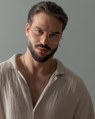 portrait of handsome man with glasses looking forward and posing