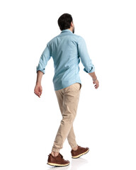 behind view of young man looking forward and stepping