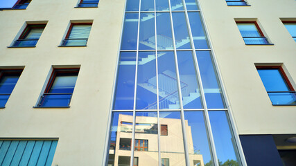 Modern apartment building in a residential area of ​​a city. Contemporary residential building exterior in the daylight. 