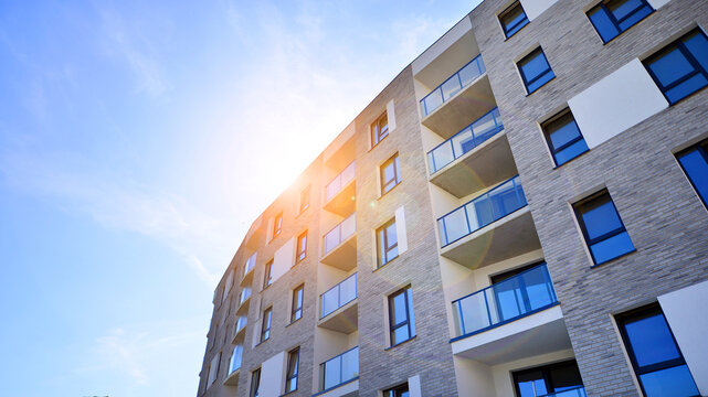 Modern apartment building in a residential area of ​​a city. Contemporary residential building exterior in the daylight. 