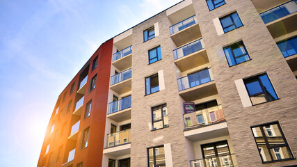 Modern apartment building in a residential area of ​​a city. Contemporary residential building exterior in the daylight. 