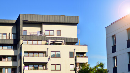 Fototapeta premium Modern apartment building in a residential area of ​​a city. Contemporary residential building exterior in the daylight. 