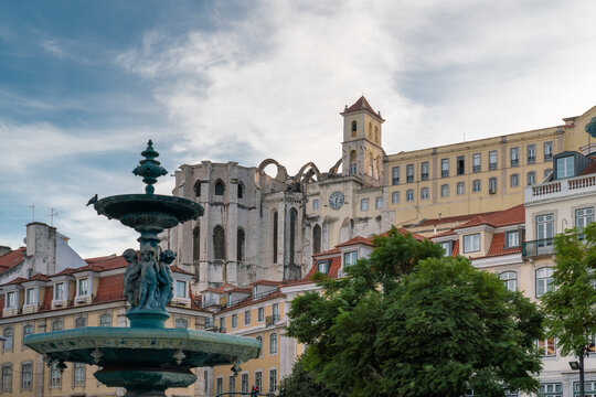 Plaza Dom Pedro IV in the city center of Lisbon. View of "Fonte Sul do Rossio" Fountain.  In background is Carmo Convent Archaeological museum. Travel destination
