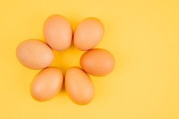 The Fresh eggs on yellow background.