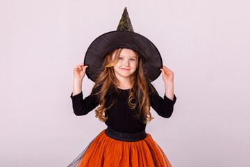 Halloween Party girl. Happy Halloween Witch. Happy laughing child girl in witch costume on...