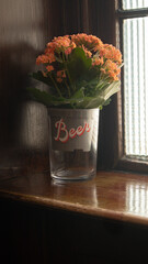 flowers in a glass by window