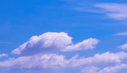 Fototapeta na wymiar Group of white fluffy clouds floating on blue sky background, beautiful cloudscape view
