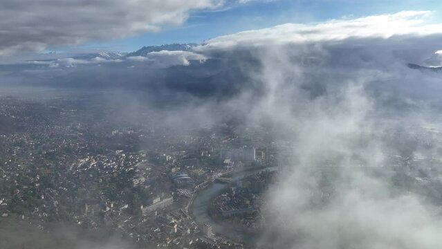 high altitude aerial shot over Grenoble city France sunny day mountains in background 