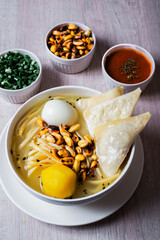 Chicken soup with fried wuantan. Peruvian food.