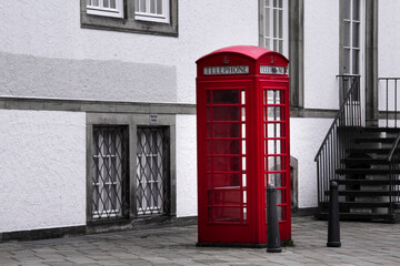 Red phone booth in Germany. black and white except for one color. High quality photo