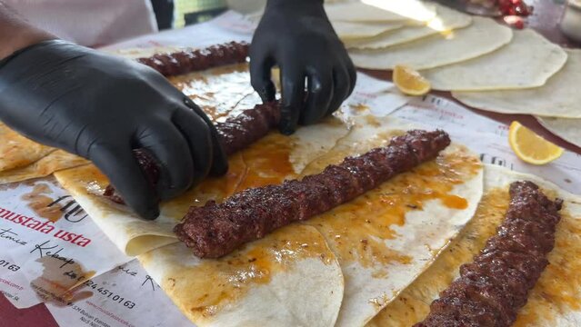  Turkish Kebab On The Grill. Barbecue grliling shish kebab , Chef turns grilled kebabs into wraps