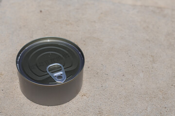 Canned tuna isolated on sand. Canned albacore-free soybeans white meat tuna packed in water.