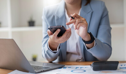 Close up mobile phone attractive Asian business woman using smartphone Space for text design online business woman working with mobile phone