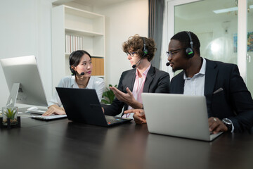 Group of business people wearing headset working actively in office. Call center, telemarketing,...