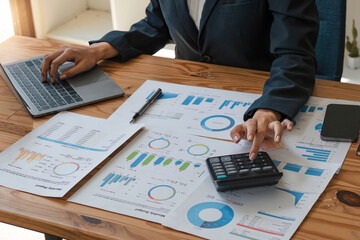 Close up businesswoman using calculator for do math finance on wooden desk in office and business...