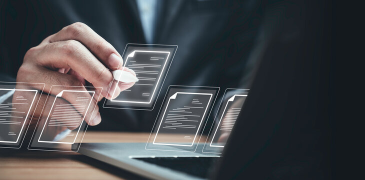 Businessman using laptop computer and touching to online electronic paper for approve ISO quality document control certification and project approval concept.