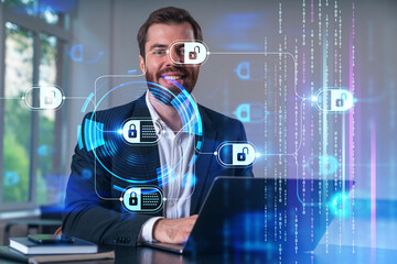 Smiling businessman in formal wear working on laptop at office workplace with smartphone and notebooks. Concept of successful business deal, agreement. Blockchain icons.