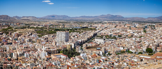 Panoramic view of downtown inland Alicante and the Bullring from the hilltop Castle Santa Barbara in Alicante, Spain on 29 August 2023 - obrazy, fototapety, plakaty