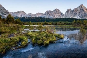 The landscape depicts majestic mountains in Poland, with their peaks covered in snow or lush greenery depending on the season. The scenery is characterized by rugged terrain