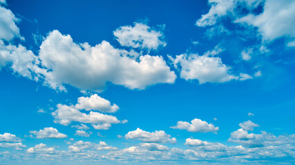 Naklejka na ściany i meble The high cumulus clouds against the blue sky create a stunning background