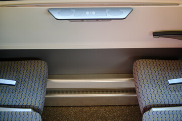 Interior of the passenger compartment of a passenger train with wireless charging for phone