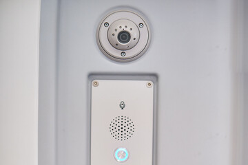 Intercom for passengers with train driver and CCTV camera. Security camera on the wall of a transport