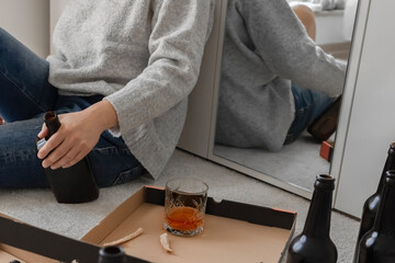 Alcoholism, alcohol addiction and people concept - drunk woman or female alcoholic drinking at home. Female alcoholism.