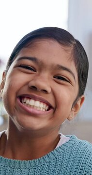 Selfie, face and laughing with a girl child closeup in the living room of her home for playful recording. Portrait, smile and happy young indian kid in her house for a video, movie or film for youth