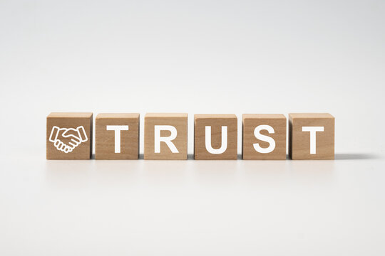 Wooden blocks with the word Trust as confident in a person