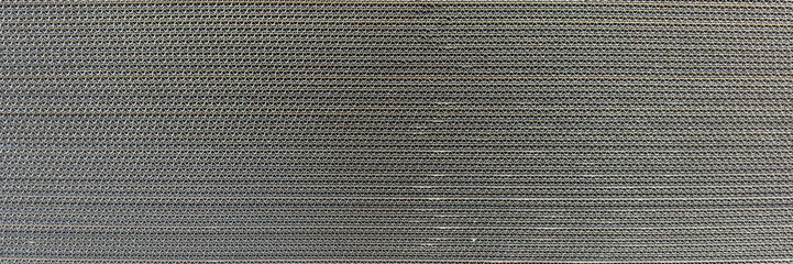 Texture of multilayer cardboard close-up. Large sheets of cardboard are stacked in a factory to make packaging boxes. Material for the production of cardboard boxes. Side view.