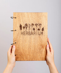 Herbarium book, wood cover in hand