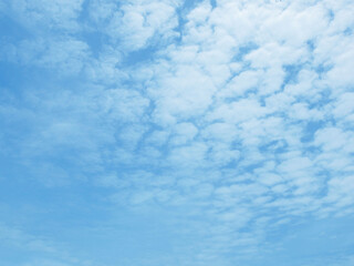 Soft white clouds against blue sky background. Summer blue sky with fluffy cloud