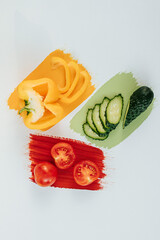 on a white background, strokes of paint in red, orange and green, and on them a cross-section of a...