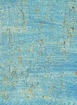 Wall background, texture, made of rusted metal. An old blue and rusty surface with faded uneven color and cracks. Abstract rust pattern on a fulvous (lurid) surface. Metallic fence sketches and colors