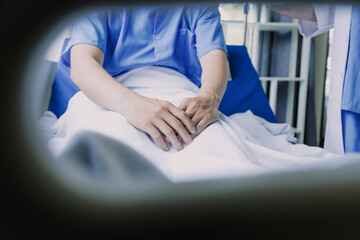 Professional female doctor smiles and shows positive examination results to young, joyful man. Handsome, happy guy with glasses at doctor's appointment in modern office of medical institution.