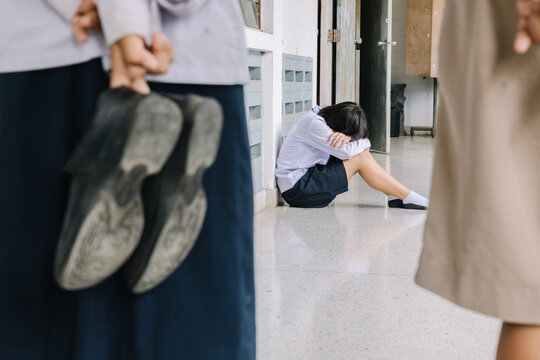 Thai student bullying victim by classmates crying sadly being bullied, concept of being bullied by schoolmates causing stress and physical and psychological harm..