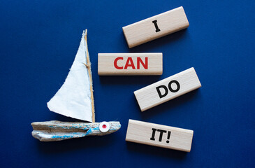 I can do it symbol. Concept words I can do it on wooden blocks. Beautiful deep blue background with boat. Business and I can do it concept. Copy space.