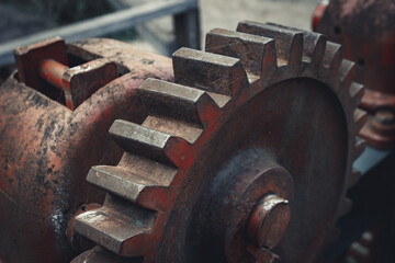 Close-up of Durable Metallic Machinery in Construction. Metalwork equipment in close-up view, featuring alloy iron. Mechanical red cogwheel in an industrial machine.