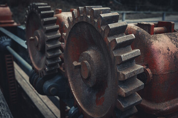 Close-up of Durable Metallic Machinery in Construction. Metalwork equipment in close-up view, featuring alloy iron. Mechanical red cogwheel in an industrial machine. - obrazy, fototapety, plakaty