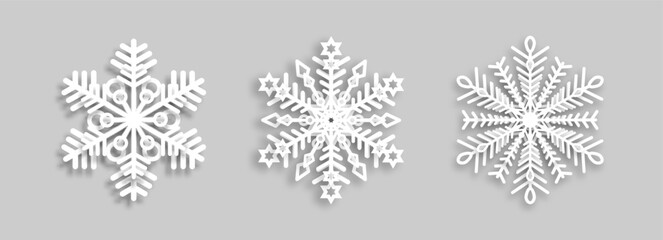 White snowflakes with paper effect on a gray background for winter design. A set of snowflakes. A symbol of Christmas and New Year. Vector EPS 10.